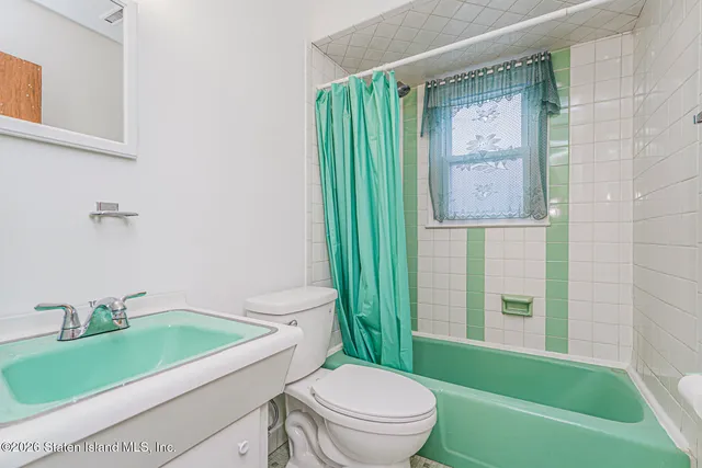 a bathroom with a toilet sink and tub