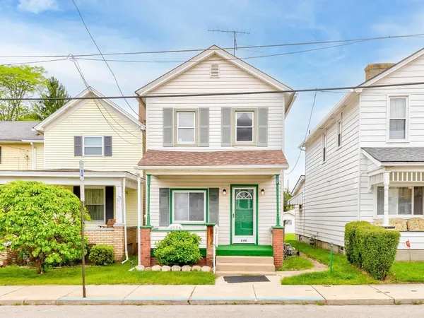 a front view of a house with a yard