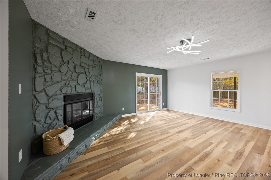 6541 Green Meadow Road Fayetteville, NC 28304 - Photo 12 of 35 a bedroom with a bed and a fireplace