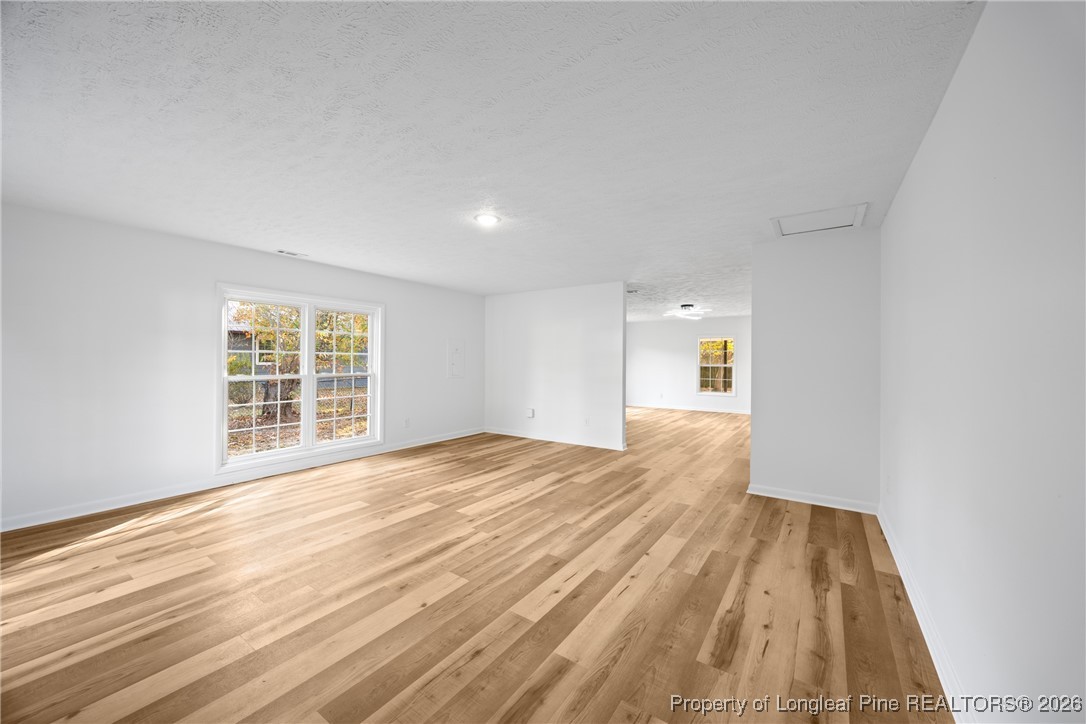 6541 Green Meadow Road Fayetteville, NC 28304 - Photo 14 of 35 a view of an empty room with wooden floor and a window