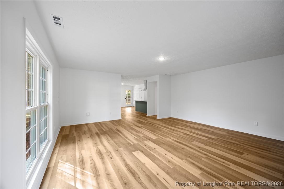 6541 Green Meadow Road Fayetteville, NC 28304 - Photo 15 of 35 a view of empty room with wooden floor and fan