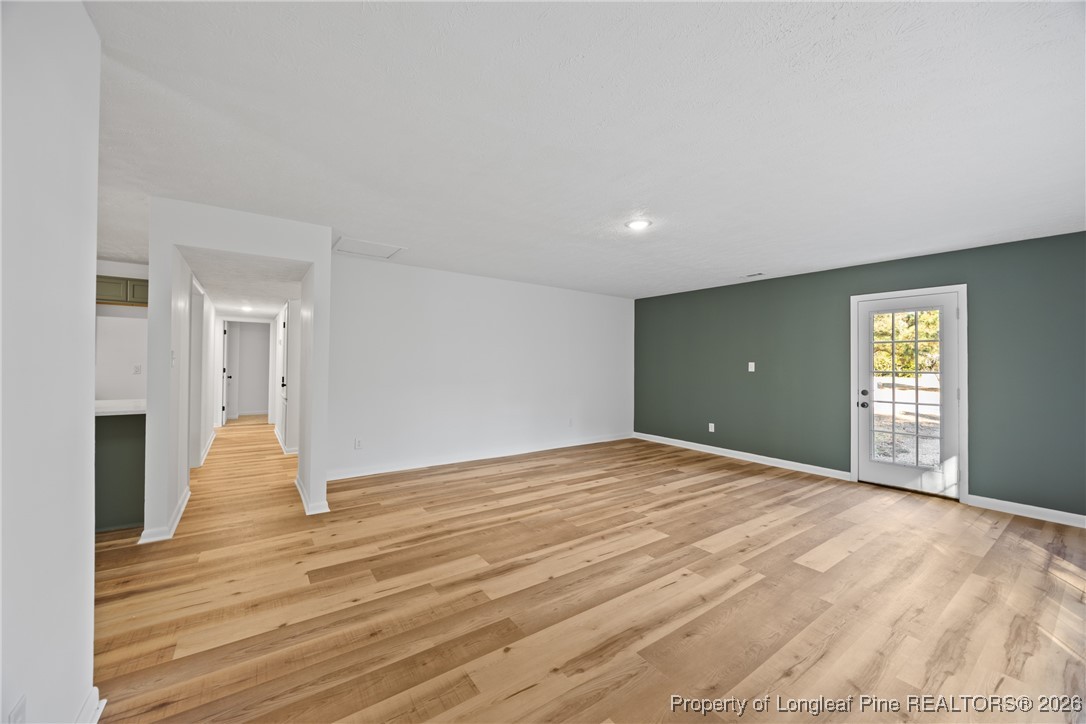 6541 Green Meadow Road Fayetteville, NC 28304 - Photo 16 of 35 a view of an empty room with wooden floor and a window
