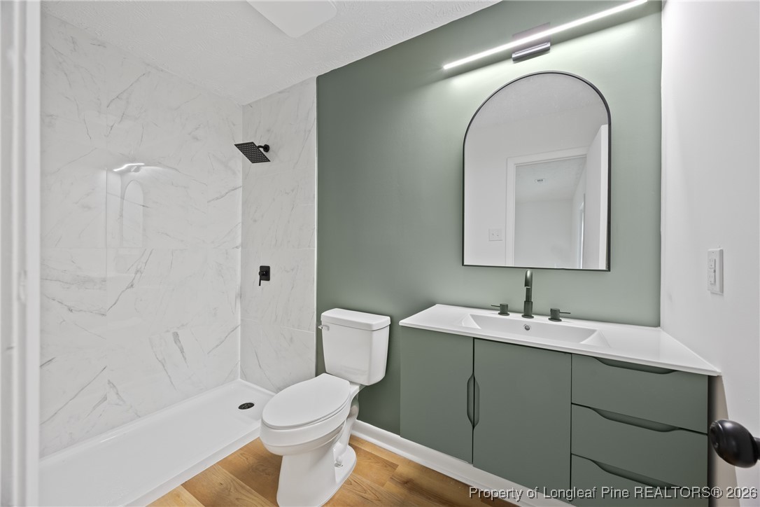 6541 Green Meadow Road Fayetteville, NC 28304 - Photo 21 of 35 a bathroom with a toilet sink and mirror