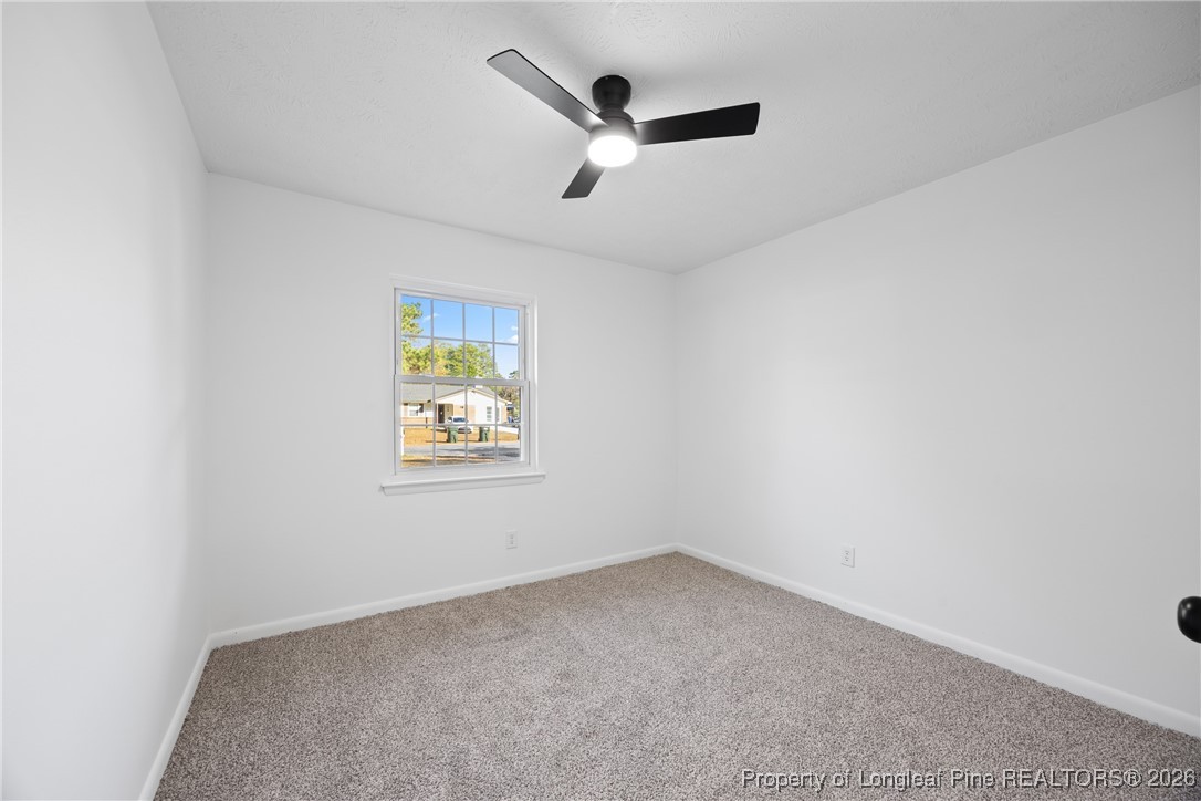 6541 Green Meadow Road Fayetteville, NC 28304 - Photo 22 of 35 an empty room with ceiling fan and window