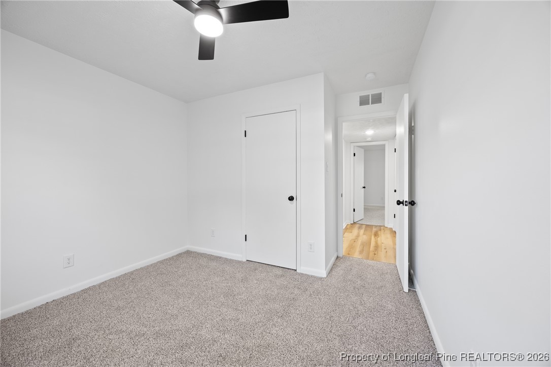 6541 Green Meadow Road Fayetteville, NC 28304 - Photo 23 of 35 an empty room with a ceiling fan and window