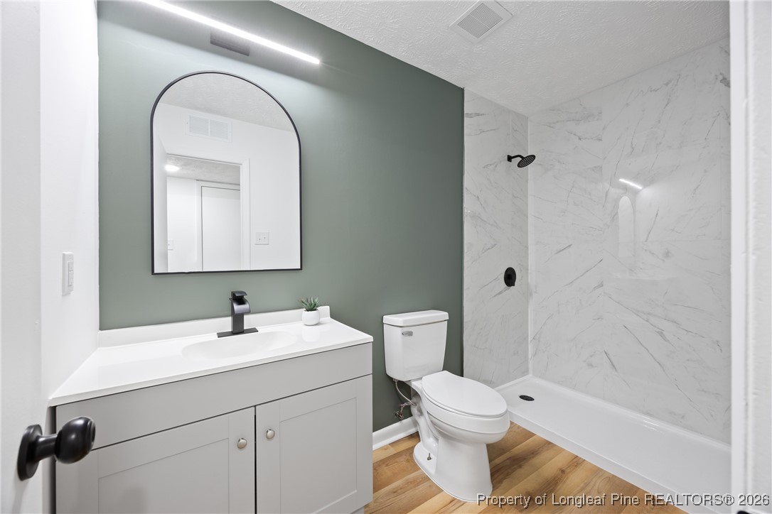 6541 Green Meadow Road Fayetteville, NC 28304 - Photo 25 of 35 a bathroom with a toilet sink and mirror