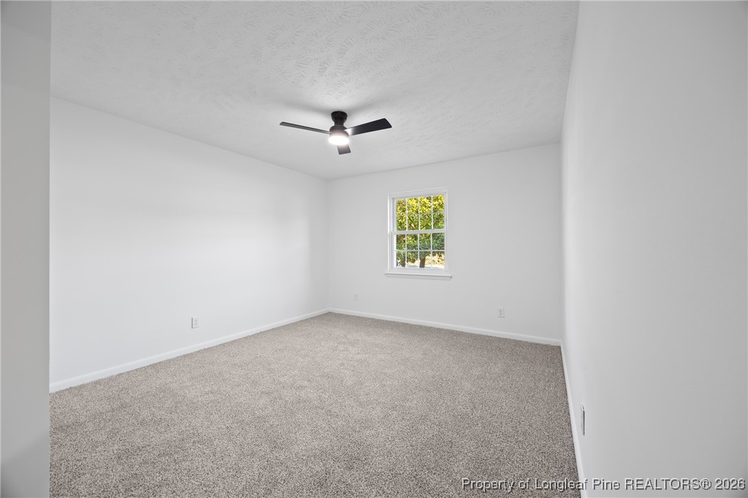6541 Green Meadow Road Fayetteville, NC 28304 - Photo 26 of 35 an empty room with windows and painted walls