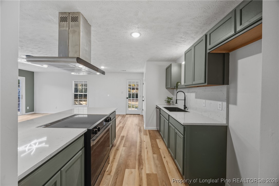 6541 Green Meadow Road Fayetteville, NC 28304 - Photo 6 of 35 a kitchen with granite countertop stainless steel appliances a sink stove top oven and cabinets