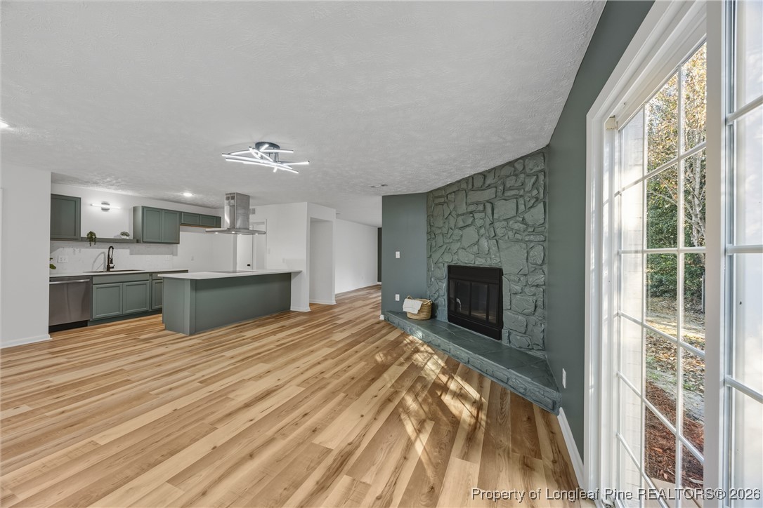 6541 Green Meadow Road Fayetteville, NC 28304 - Photo 10 of 35 a view of a kitchen with furniture and a fireplace
