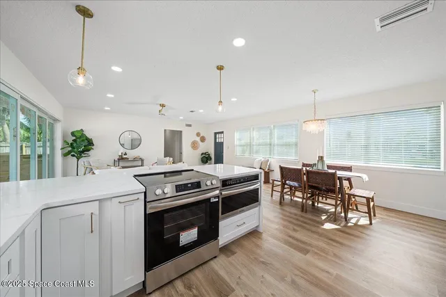 a kitchen with a stove a sink and a window