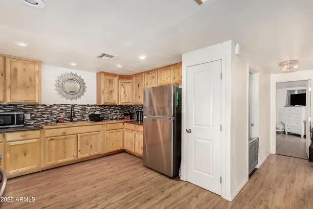 a kitchen with stainless steel appliances granite countertop a refrigerator and a sink