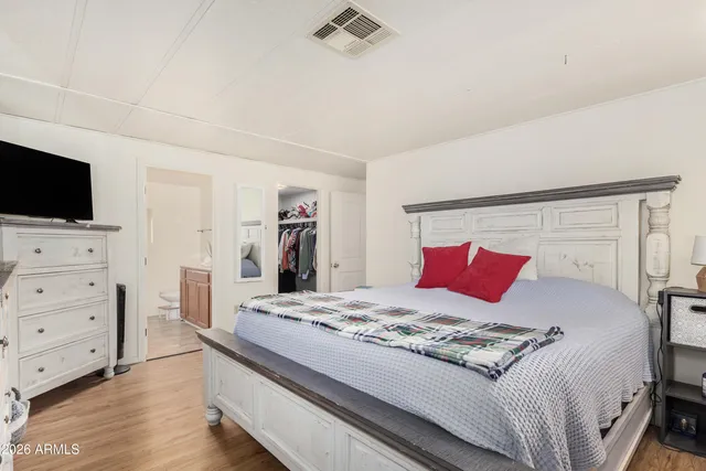 a bedroom with a bed and a flat screen tv