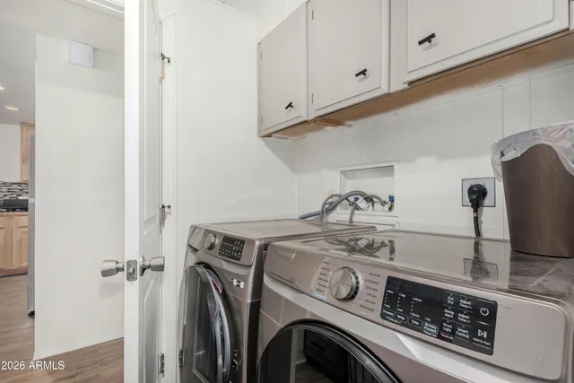 a view of a storage and utility room with washer and dryer