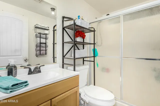 a bathroom with a sink toilet vanity and shower