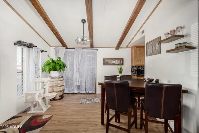 a view of a dining room with furniture and a potted plant