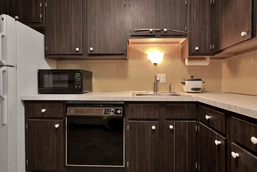 294 Codman Hill Road, Unit 33F Boxborough, MA 01719 - Photo 12 of 31 a kitchen with a sink a stove and cabinets