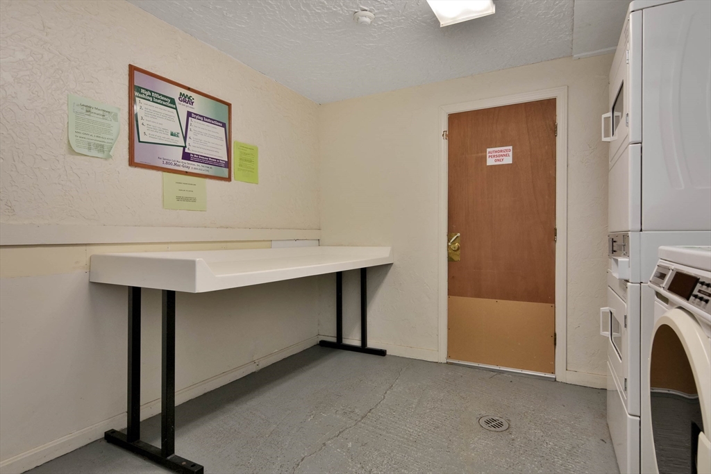 294 Codman Hill Road, Unit 33F Boxborough, MA 01719 - Photo 15 of 31 a room with a table and a fireplace