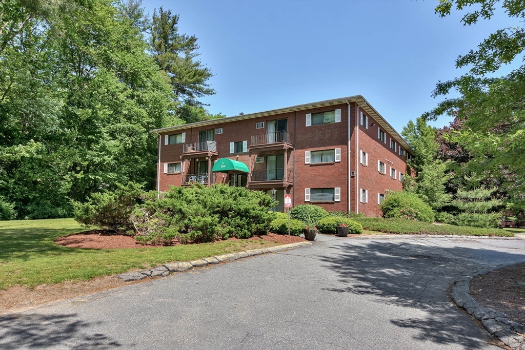294 Codman Hill Road, Unit 33F Boxborough, MA 01719 - Photo 17 of 31 a front view of a house with a yard and a garage