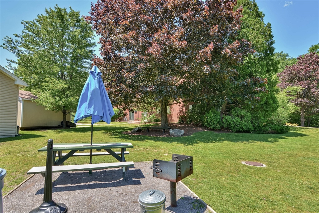 294 Codman Hill Road, Unit 33F Boxborough, MA 01719 - Photo 21 of 31 a view of backyard with swimming pool and green space