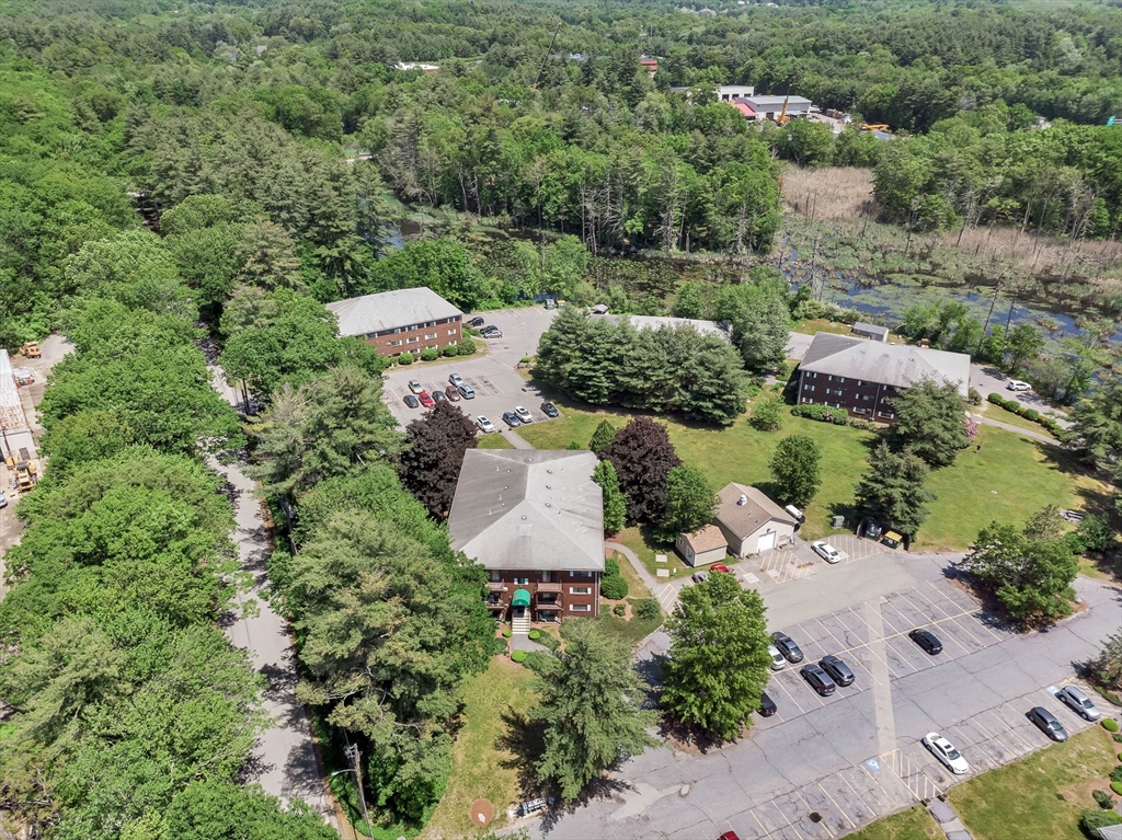 294 Codman Hill Road, Unit 33F Boxborough, MA 01719 - Photo 27 of 31 an aerial view of a house with yard and outdoor seating