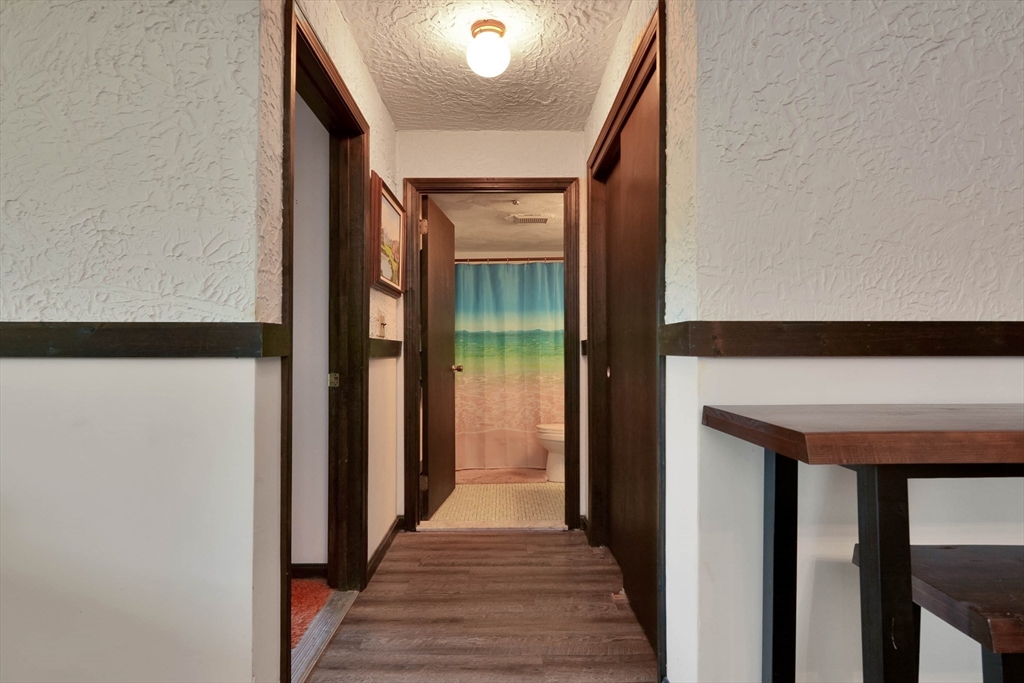 294 Codman Hill Road, Unit 33F Boxborough, MA 01719 - Photo 3 of 31 a view of a hallway with wooden floor and staircase