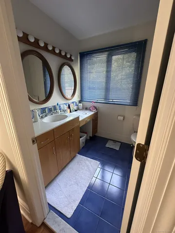 a kitchen with wooden cabinets a sink and a stove