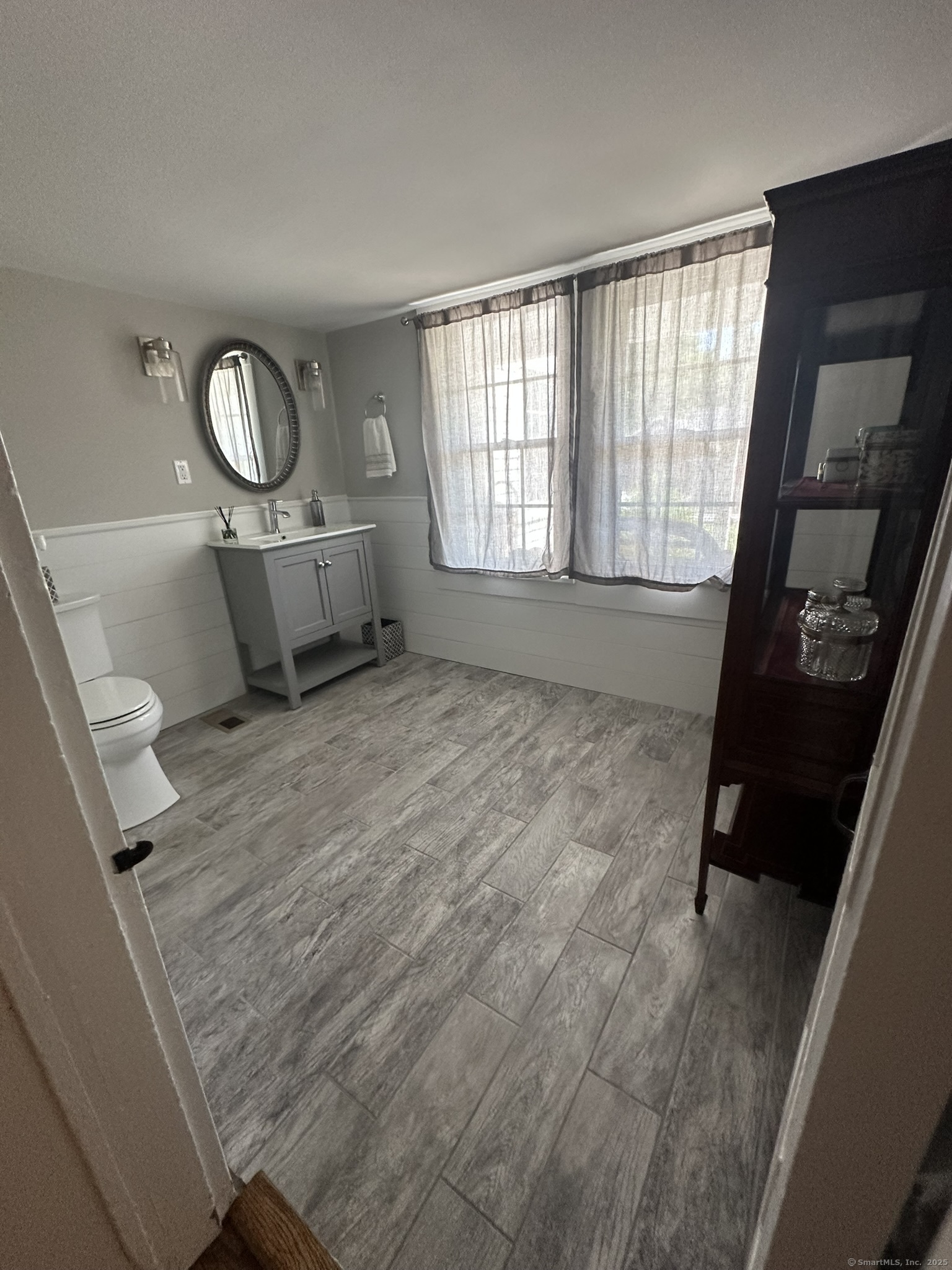 57 Castle Meadow Road Newtown, CT 06470 - Photo 19 of 21 a view of a livingroom with wooden floor and a window