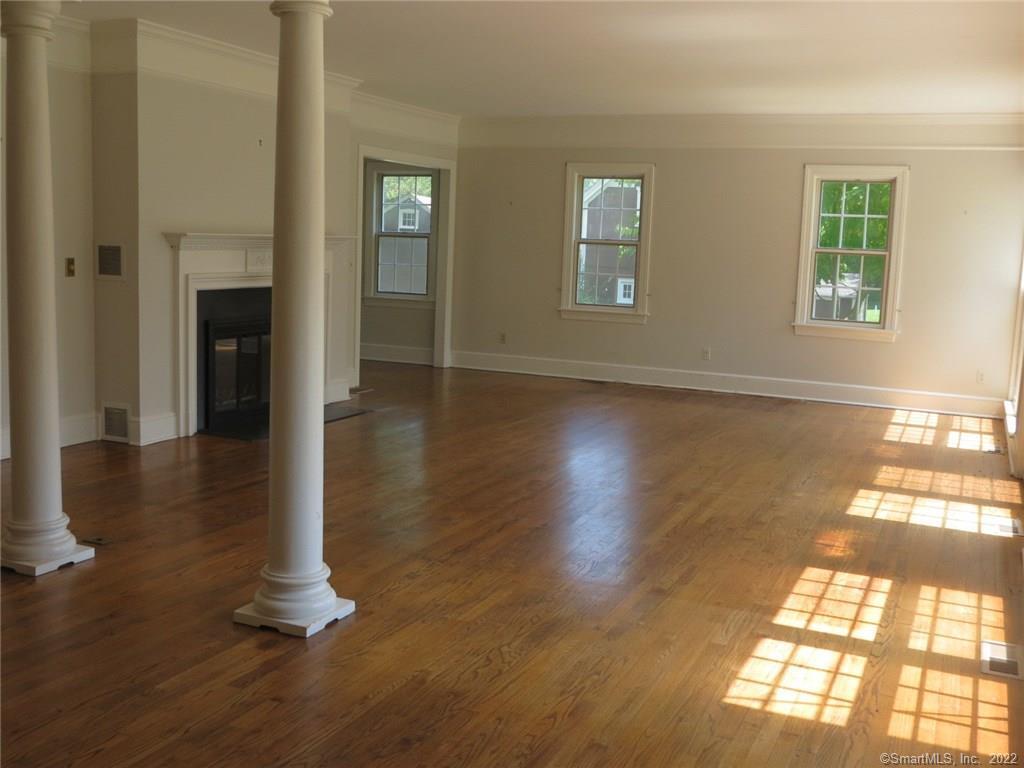 57 Castle Meadow Road Newtown, CT 06470 - Photo 2 of 21 an empty room with wooden floor and windows