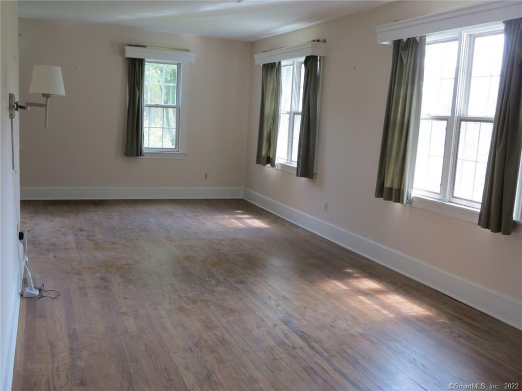 57 Castle Meadow Road Newtown, CT 06470 - Photo 6 of 21 a view of an empty room with wooden floor and a window
