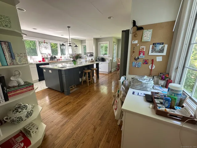 a living room with furniture and a kitchen