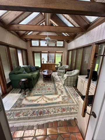 a living room with furniture and a chandelier