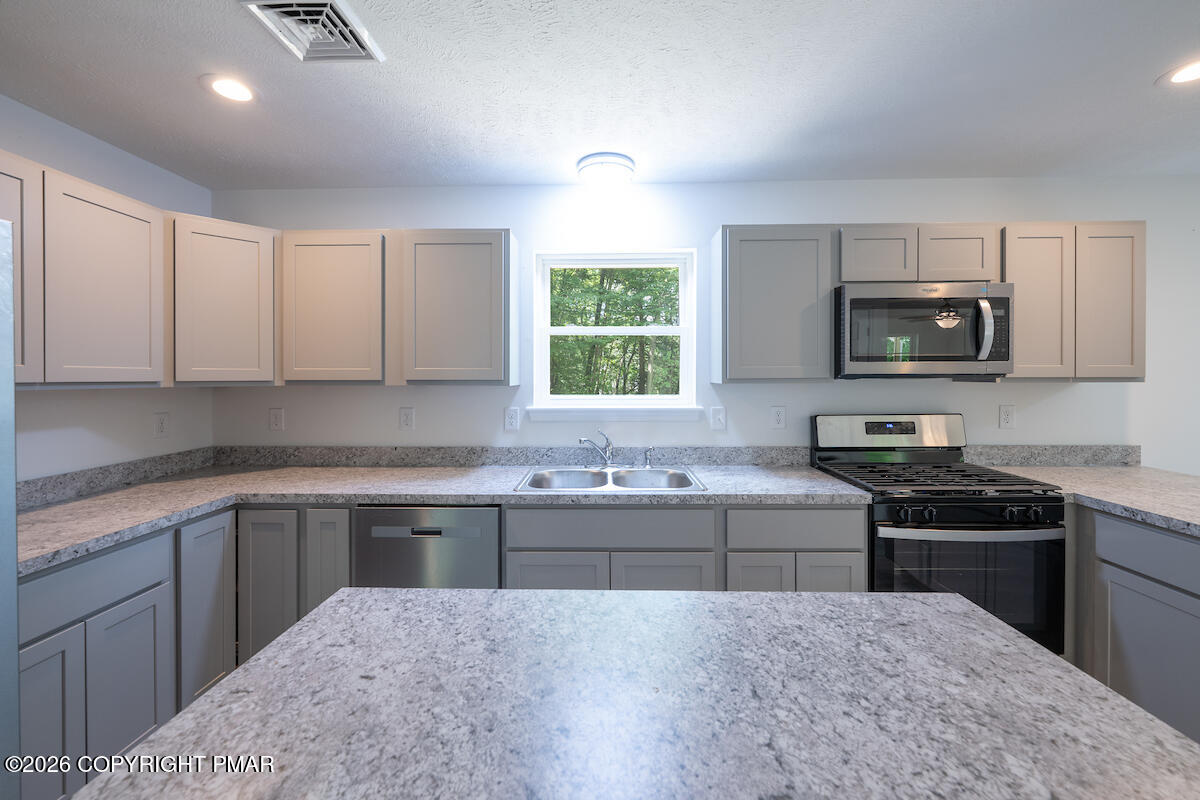 1125 Glouster Road, Unit 3209 Tobyhanna, PA 18466 - Photo 11 of 53 a kitchen with a sink and a stove top oven