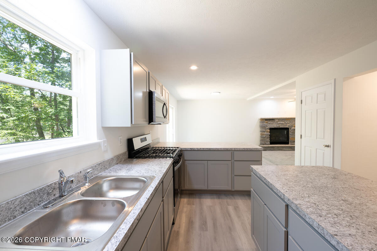 1125 Glouster Road, Unit 3209 Tobyhanna, PA 18466 - Photo 14 of 53 a kitchen with a sink stove top oven and cabinets