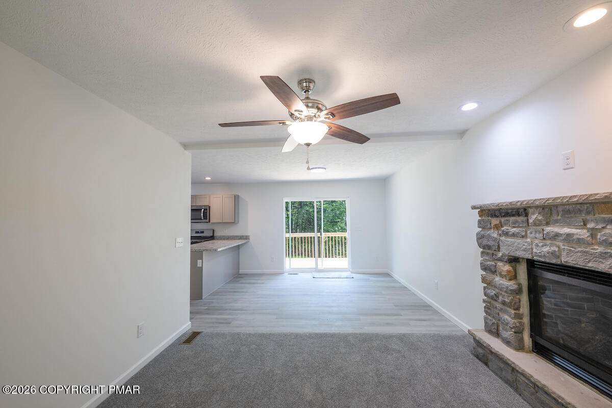 1125 Glouster Road, Unit 3209 Tobyhanna, PA 18466 - Photo 19 of 53 a view of an empty room with a fireplace and a window