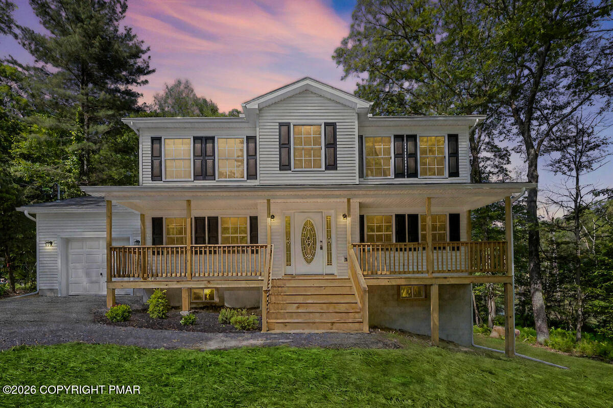 1125 Glouster Road, Unit 3209 Tobyhanna, PA 18466 - Photo 3 of 53 a view of a white house with large windows and a yard