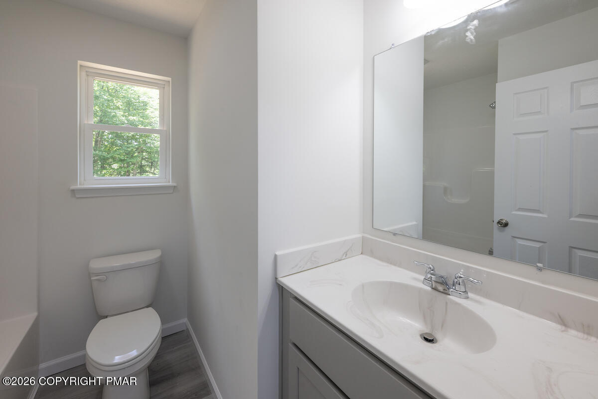 1125 Glouster Road, Unit 3209 Tobyhanna, PA 18466 - Photo 36 of 53 a bathroom with a sink toilet and a mirror