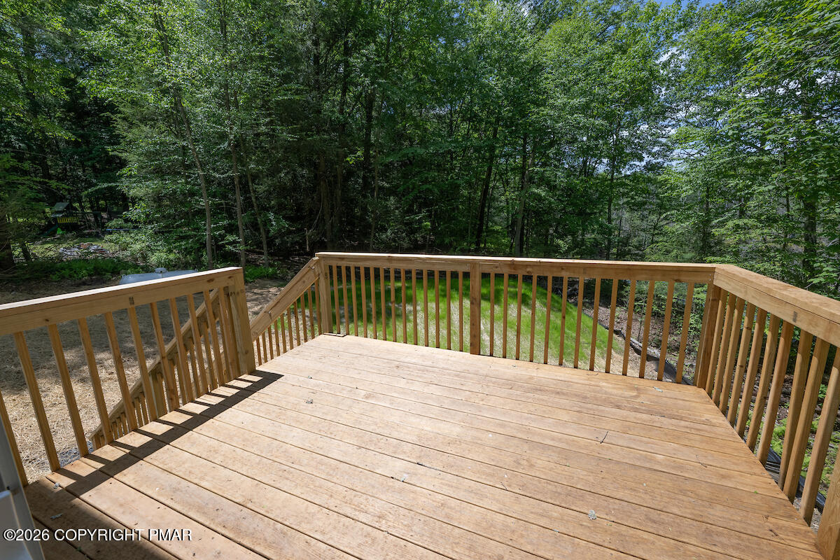 1125 Glouster Road, Unit 3209 Tobyhanna, PA 18466 - Photo 49 of 53 a balcony with wooden floor and trees in the background