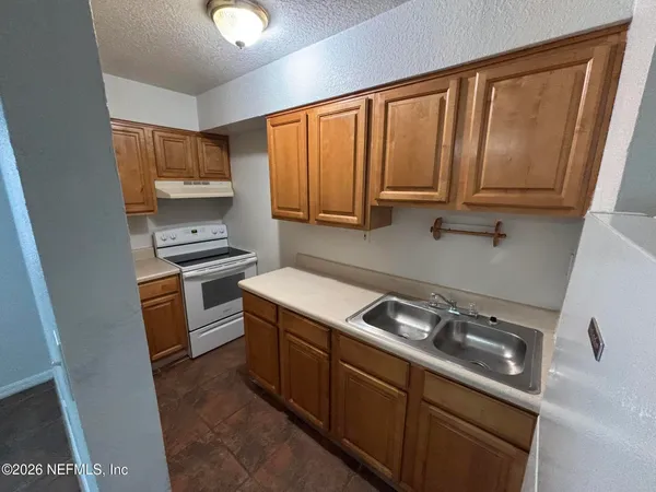 a kitchen with a stove microwave and sink