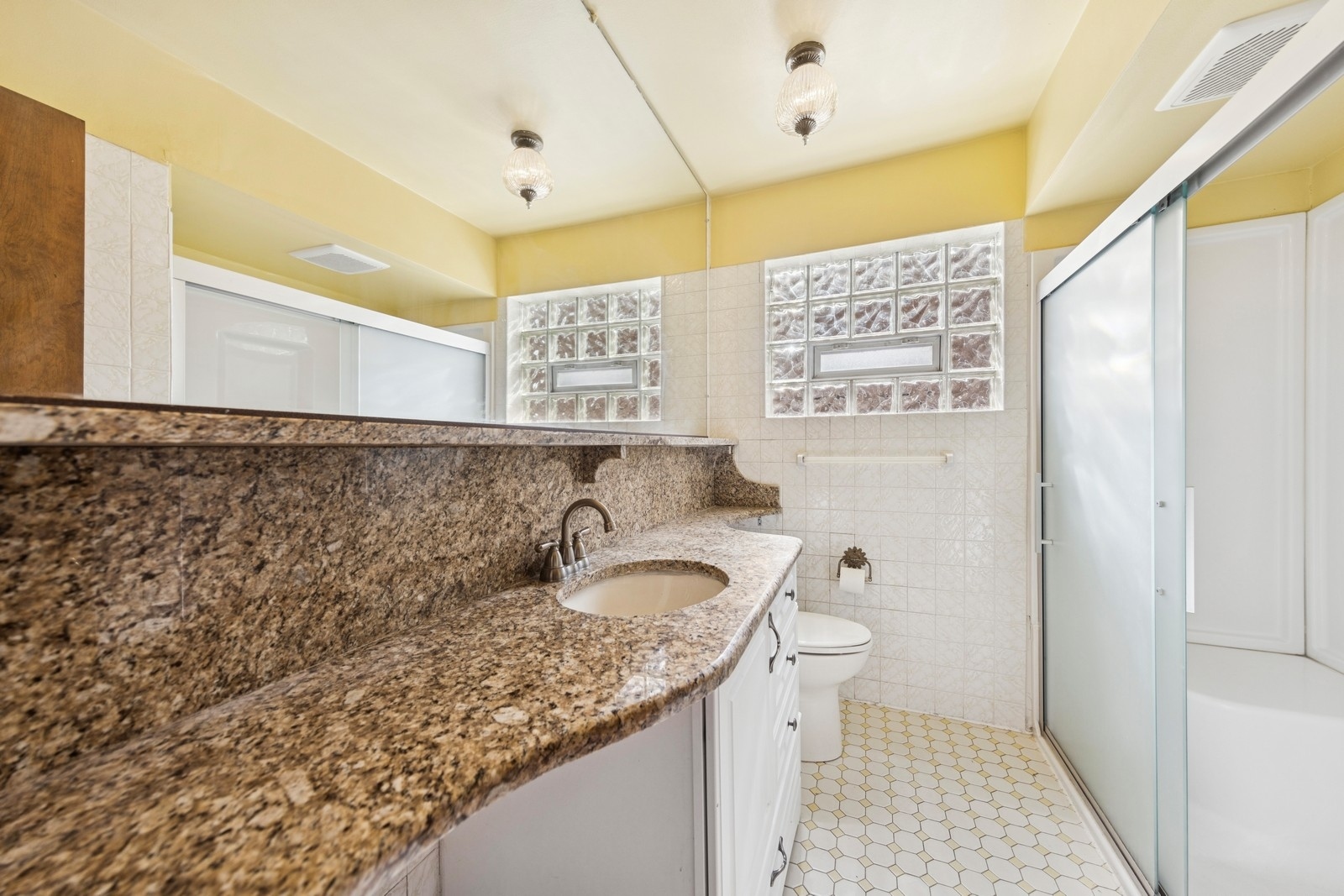 9331 South Pulaski Road Evergreen Park, IL 60805 - Photo 13 of 29 a bathroom with a granite countertop sink and a toilet