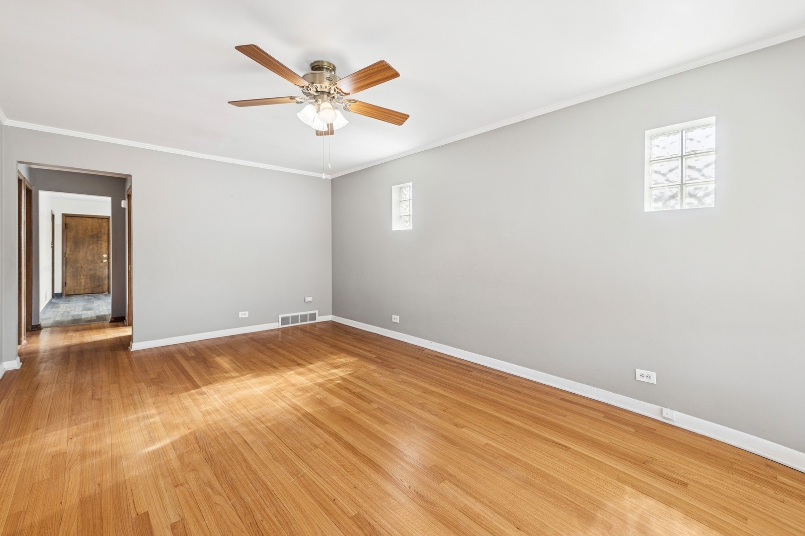 9331 South Pulaski Road Evergreen Park, IL 60805 - Photo 19 of 29 an empty room with wooden floor and ceiling fan