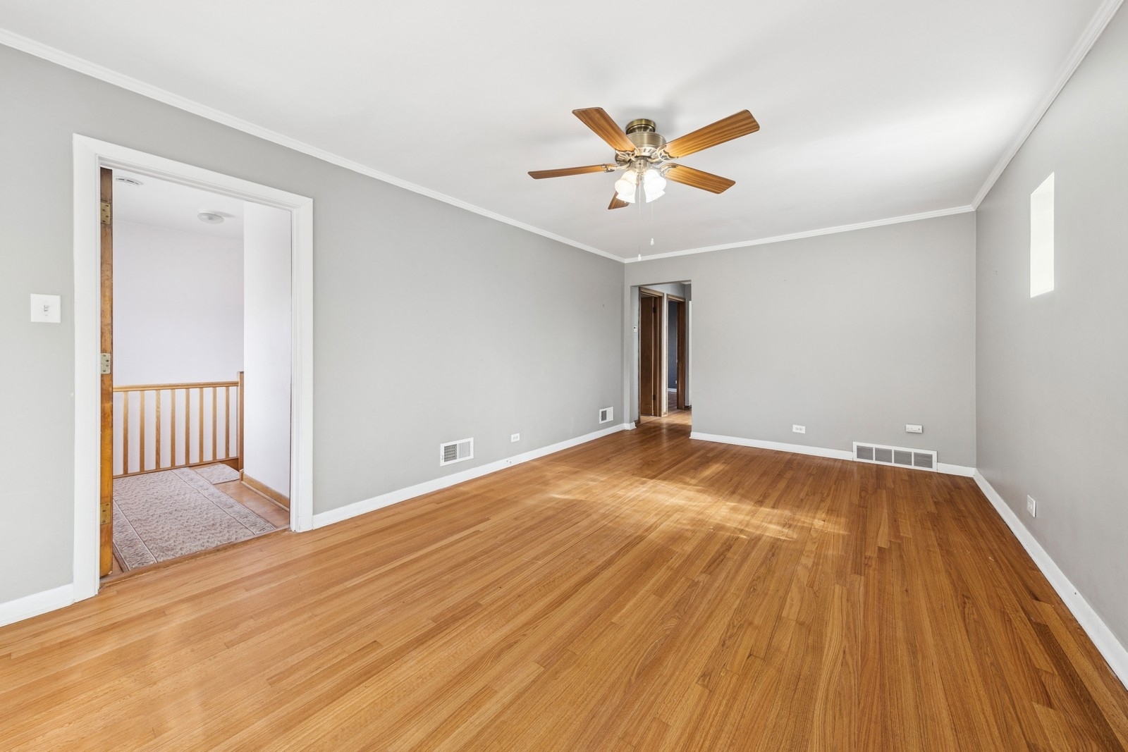 9331 South Pulaski Road Evergreen Park, IL 60805 - Photo 20 of 29 a view of a livingroom with wooden floor and a ceiling fan