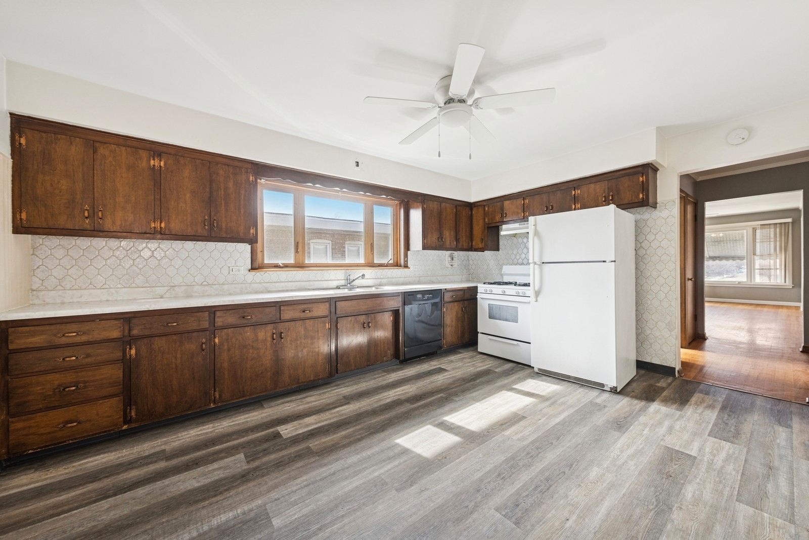 9331 South Pulaski Road Evergreen Park, IL 60805 - Photo 4 of 29 a kitchen with a refrigerator a sink and dishwasher with wooden floor