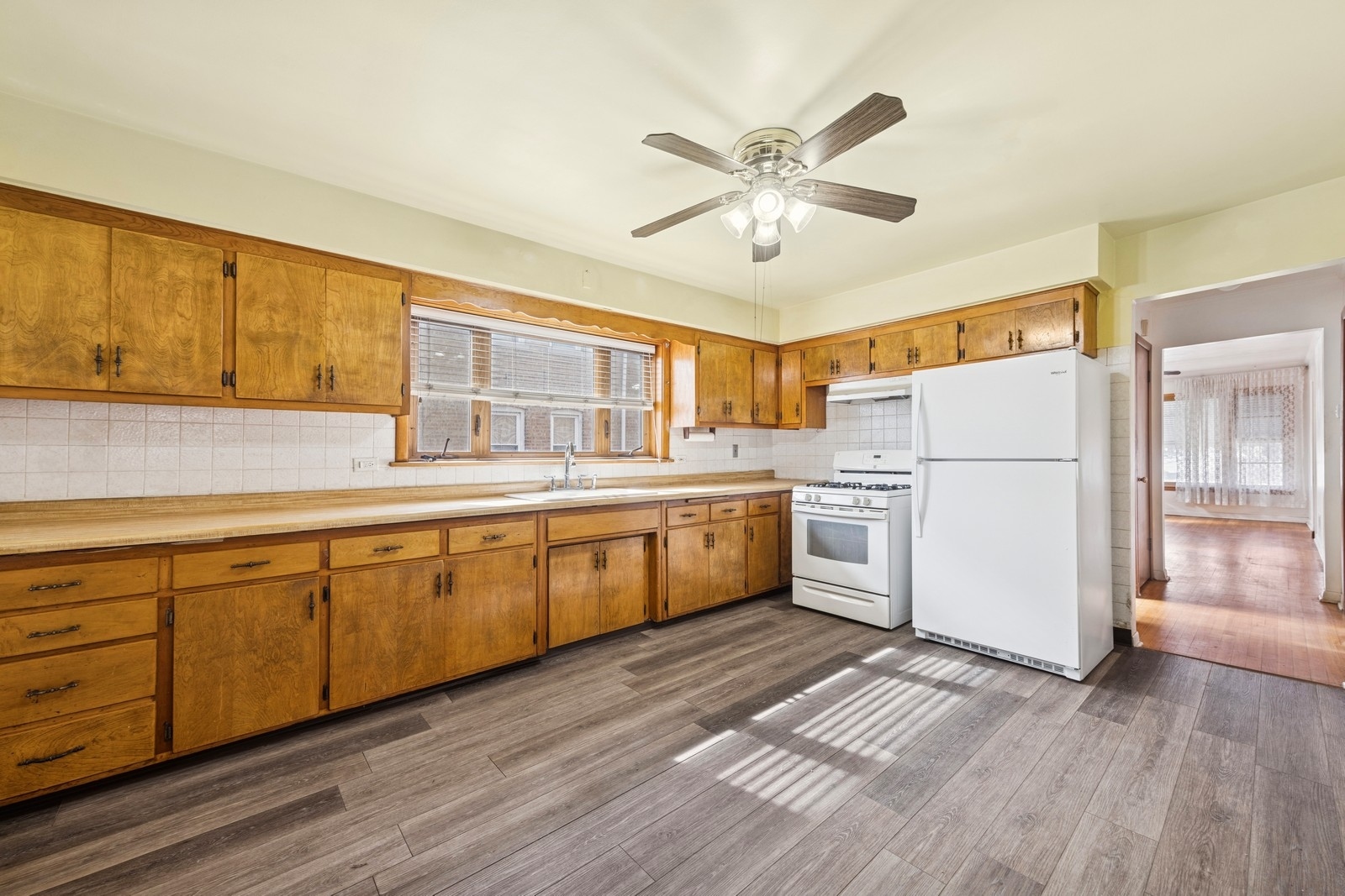 9331 South Pulaski Road Evergreen Park, IL 60805 - Photo 6 of 29 a kitchen with a white cabinets and wooden floor