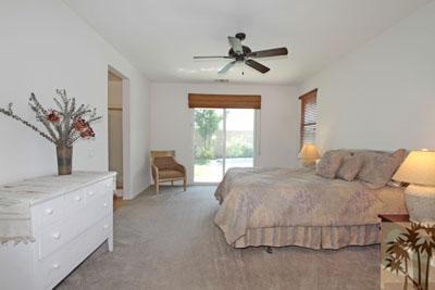 37430 Blackburn Road Indio, CA 92203 - Photo 10 of 17 a bedroom with a large bed and a chandelier
