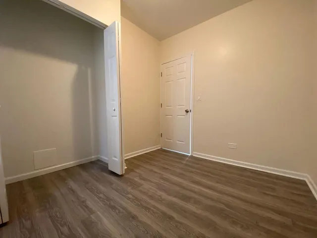 an empty room with wooden floor