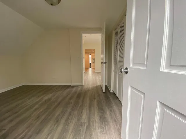 a view of a hallway with wooden floor
