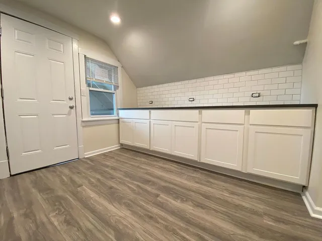 a view of a kitchen with wooden floor