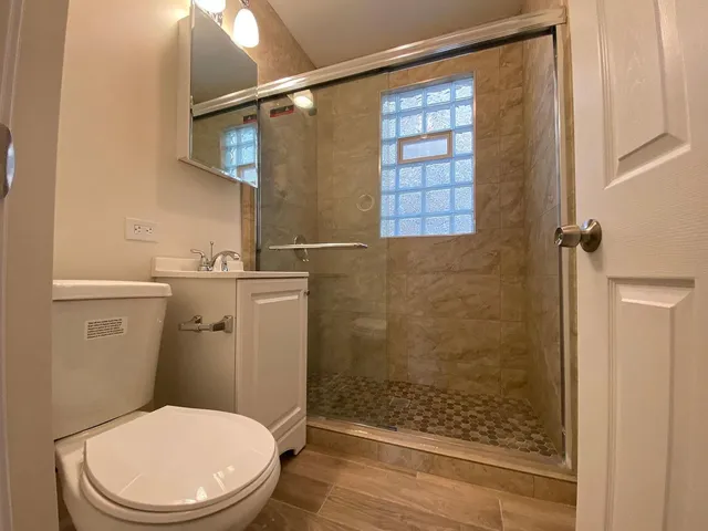 a bathroom with a toilet a sink and shower