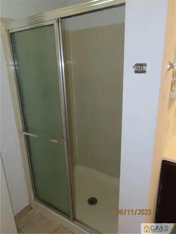a bathroom with a glass shower door