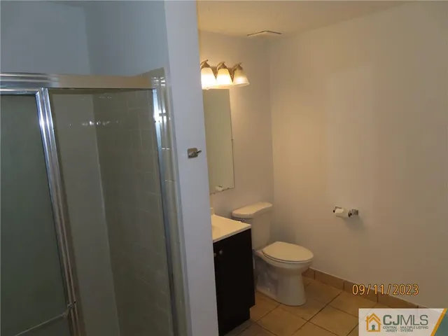 a bathroom with a toilet and a shower